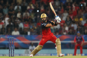 Virat Kohli playing an aggressive batting shot for Royal Challengers Bengaluru during an IPL 2026 match in a packed cricket stadium